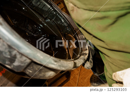 Close-Up of an Industrial Oil Drum Being Filled with Dark Liquid 125293103