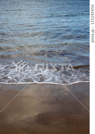 Sand beach and a line of the tide, Gran Canaria, Spain 125293450