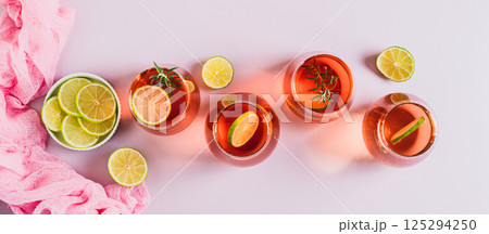 Delicious Negroni cocktail with lime and rosemary in glasses top view web banner Delicious Negroni cocktail with lime and rosemary in glasses top view web banner 125294250