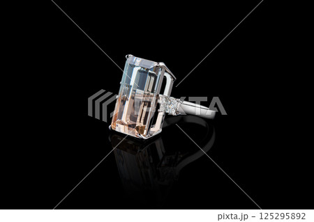 ring made of white metal, silver, gold with a stone topaz polychrome and diamonds on a black background 125295892