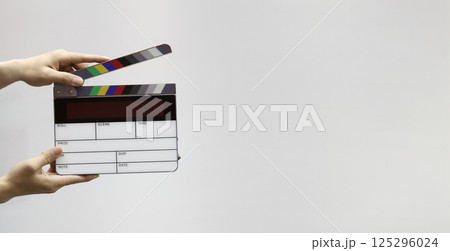 Digital film slate for filmmaker in set. Hand hitting timecode clapperboard or movie slate for Video Production. Digi number clapper board or film slates action on set. Tools in modern cinema industry Digital film slate for filmmaker in set. Hand hitting timecode clapperboard or movie slate for Video Production. Digi number clapper board or film slates action on set. Tools in modern cinema industry 125296024