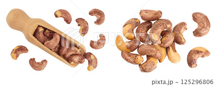 cashew nuts heap with shell in wooden scoop isolated on white background. Top view. Flat lay cashew nuts heap with shell in wooden scoop isolated on white background. Top view. Flat lay 125296806