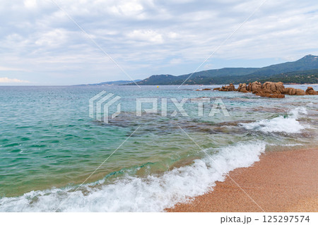 A serene coastal view featuring turquoise waters, a sandy shoreline, Corsica A serene coastal view featuring turquoise waters, a sandy shoreline, Corsica 125297574
