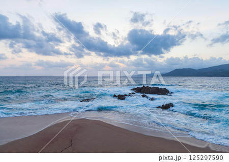Landscape of Propriano, Corsica. A picturesque shoreline with dark rocks 125297590