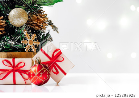 Eco-friendly artificial Christmas tree with gifts on white background. New Year concept, holiday card. 125298928