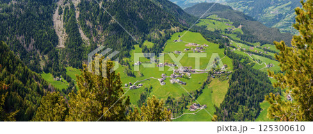 Panoramic view of mountainous green valley village in summer near Valley of Funes at Dolomites, Italy 125300610