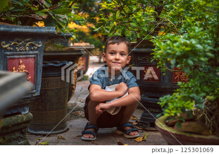Portrait of happy caucasian schoolboy child boy on park in summer 125301069