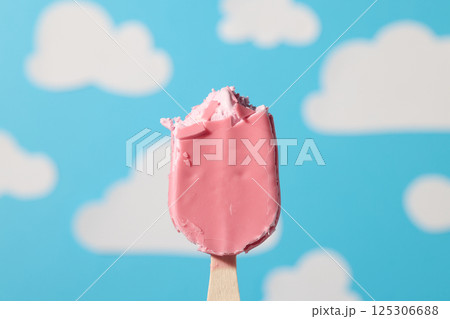 pink ice cream bar on wooden stick 125306688