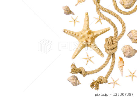 Beach items arranged with a starfish and shells for summer, isolated on white 125307387