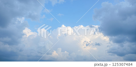 Cloudscape with dramatic soft lighting in blue sky showing moody weather change and atmosphere for nature climate concepts Cloudscape with dramatic soft lighting in blue sky showing moody weather change and atmosphere for nature climate concepts 125307484
