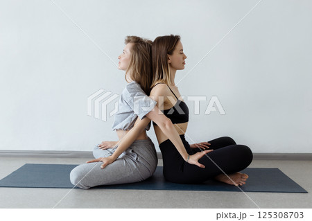 sporty yogi sisters doing fitness training. pair, couple yoga sporty yogi sisters doing fitness training. pair, couple yoga 125308703
