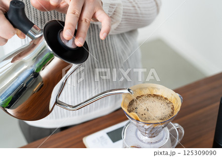 ハンドドリップでコーヒーを淹れる女性 ハンドドリップでコーヒーを淹れる女性 125309090