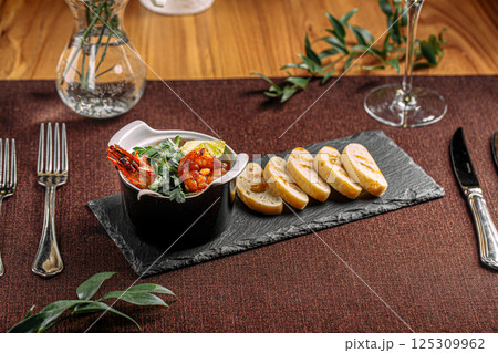 Portion of delicacy royal shrimp with toasted bread Portion of delicacy royal shrimp with toasted bread 125309962
