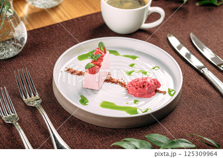 Portion of pink raspberry mousse dessert Portion of pink raspberry mousse dessert 125309964