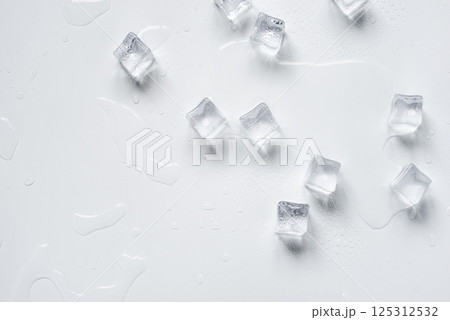Melting ice cubes in a splash of water on a white background Melting ice cubes in a splash of water on a white background 125312532