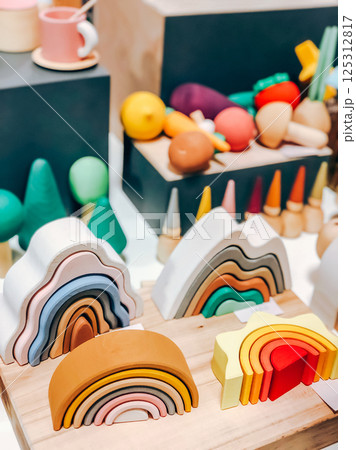 Colorful wooden rainbow toys and shapes for playful decor in playroom setting Colorful wooden rainbow toys and shapes for playful decor in playroom setting 125312817