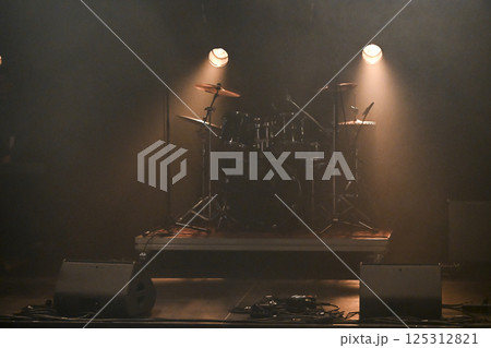 Exciting live concert atmosphere with dramatic lighting and eager audience anticipation Exciting live concert atmosphere with dramatic lighting and eager audience anticipation 125312821