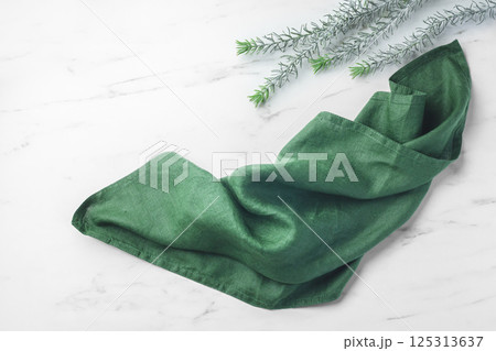 Green linen kitchen cloth on marble table background, top view Green linen kitchen cloth on marble table background, top view 125313637