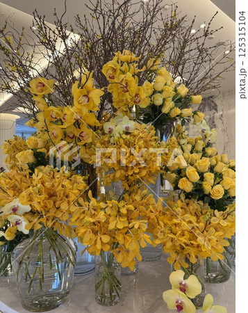 Bright yellow flower arrangement in a hotel  125315104