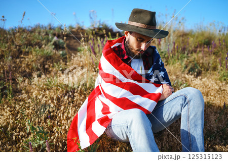 4th of July. American Flag.Patriotic holiday. Traveler with the flag of America. Beautiful sunset light. American style. 125315123