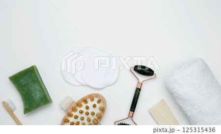 Sustainable self-care concept. Eco-friendly beauty products: massage brush, marble roller, towel, reusable cotton pads 125315436