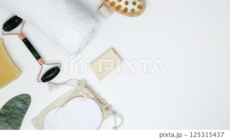 Sustainable self-care concept. Eco-friendly beauty products: massage brush, marble roller, towel, reusable cotton pads 125315437