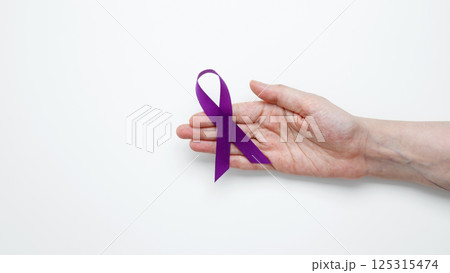 Purple ribbon held, symbol of support. Purple Epilepsy Awareness Day Purple ribbon held, symbol of support. Purple Epilepsy Awareness Day 125315474