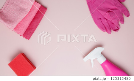 Household cleaning and hygiene concept. Pink cleaning supplies including rubber gloves, spray bottle, sponge, and microfiber cloths Household cleaning and hygiene concept. Pink cleaning supplies including rubber gloves, spray bottle, sponge, and microfiber cloths 125315480
