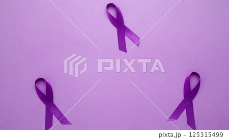 Purple ribbon held, symbol of support.Purple Epilepsy Awareness Day Purple ribbon held, symbol of support.Purple Epilepsy Awareness Day 125315499