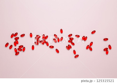 Red pills and capsules scattered. Concept of medicine, healthcare, and pharmaceutical industry Red pills and capsules scattered. Concept of medicine, healthcare, and pharmaceutical industry 125315521