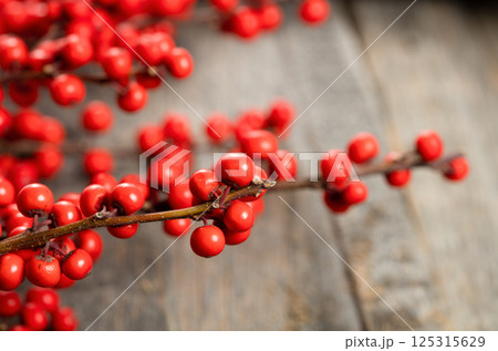 red berries on wooden background red berries on wooden background 125315629