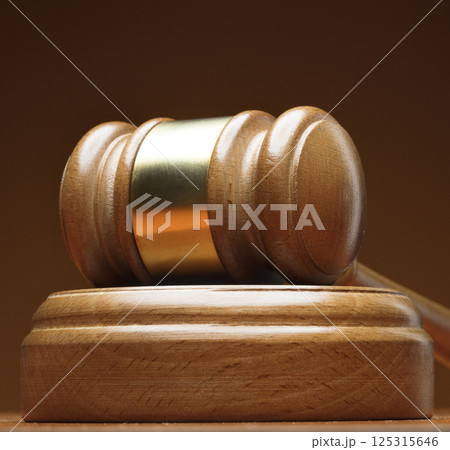 Wooden gavel on brown background 125315646