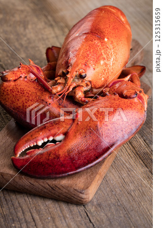 Boiled lobster on wooden background Boiled lobster on wooden background 125315659