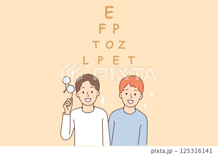 Vision test for children standing near pyramid of letters and smiling at screen. 125316141