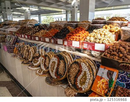 Display case with colorful nuts and dried fruits at a traditional oriental bazaar in Samarkand 125316988