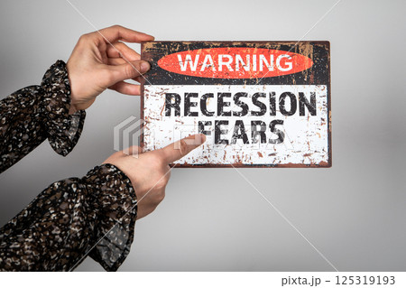 Recession Fears. Warning sign with text in the hands of a woman Recession Fears. Warning sign with text in the hands of a woman 125319193