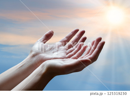 The outstretched hands of a praying man The outstretched hands of a praying man 125319230