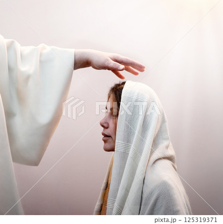 Blessing hand above the head of a woman in a headscarf Blessing hand above the head of a woman in a headscarf 125319371