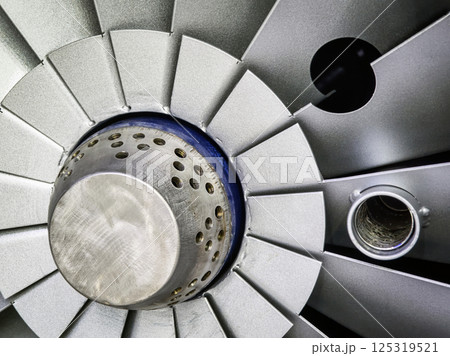 Close-up view of an aircraft engine turbine showcasing intricate design and engineering details 125319521