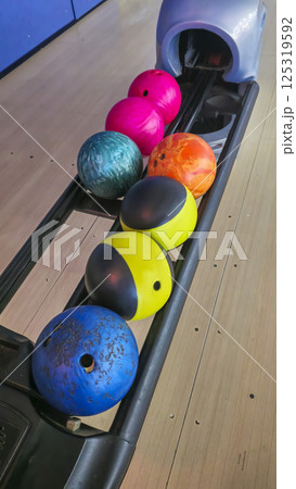 Sports hall for bowling. Pin lanes and colorful balls. Family recreation. 125319592