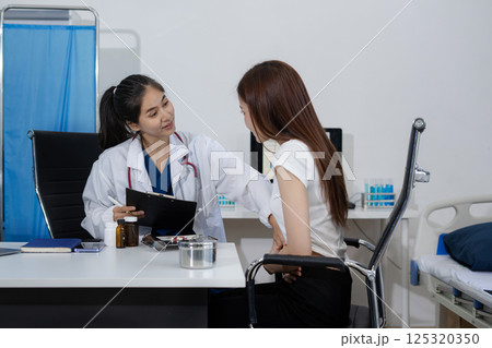 Concerned woman patient patient talks with healthcare professional. 125320350