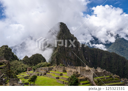 Panoramic view of Machu Picchu ruins surrounded by misty mountains, Peru Panoramic view of Machu Picchu ruins surrounded by misty mountains, Peru 125321531