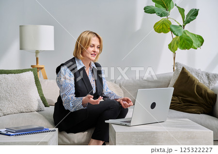 Business middle aged woman having video conference chat using laptop 125322227