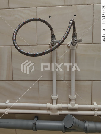 piping system installation view with water connections in residential setting. close-up. piping system installation view with water connections in residential setting. close-up. 125323470