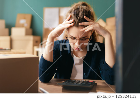 Woman working in a warehouse. 125324115