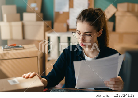 Woman working in a warehouse. 125324118