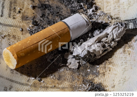 Cigarette butt and ash close up Cigarette butt and ash close up 125325219