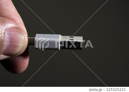 hand holding usb plug close up 125325221