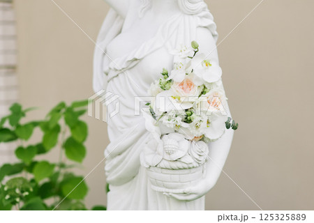 Close Up Of Floral Bouquet On Statue Close Up Of Floral Bouquet On Statue 125325889