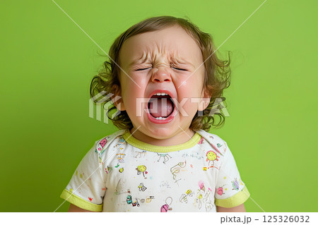 portrait of a crying child on a green background portrait of a crying child on a green background 125326032